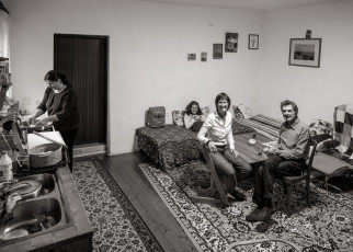 For years they have been renting out rooms in their house to a Kosovan refugee family and helping them to integrate. Photograph taken in the living room, with mother and daughter in the background.